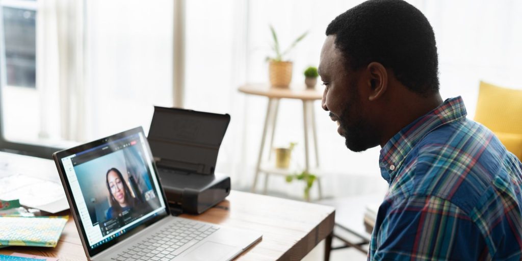 Man talking to woman on zoom using laptop.jpg