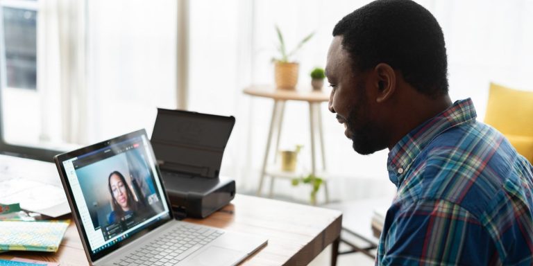 Man Talking To Woman On Zoom Using Laptop.jpg