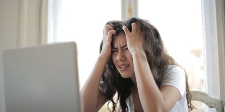 Woman Frustrated Infront Of Laptop.jpg