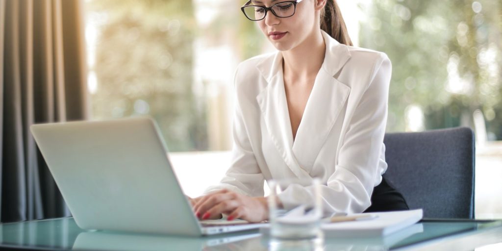 A female typing on laptop in workplace.jpg