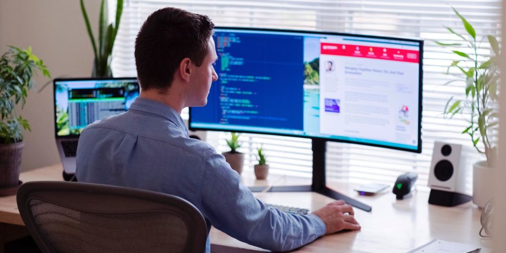 Person Using A Dual Monitor Setup In An Office.jpg