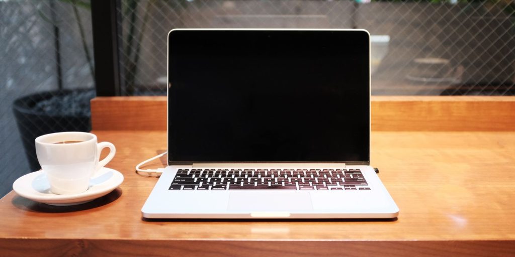 A Red Table Holds A Laptop And A Cup Of Tea.jpg