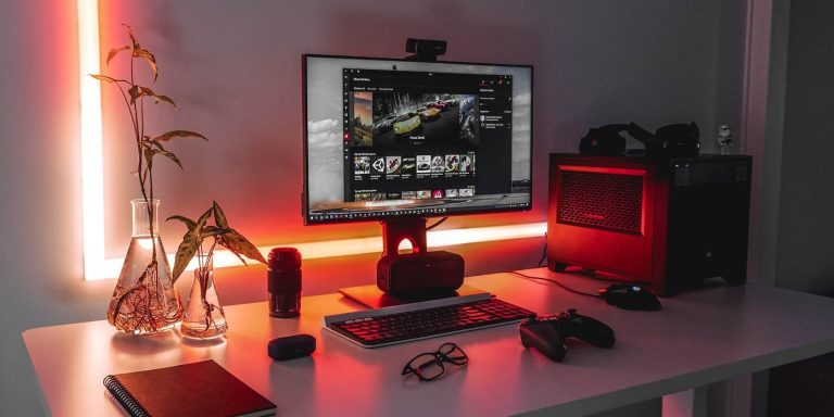 A Black Pc With A Controller On A White Table.jpg