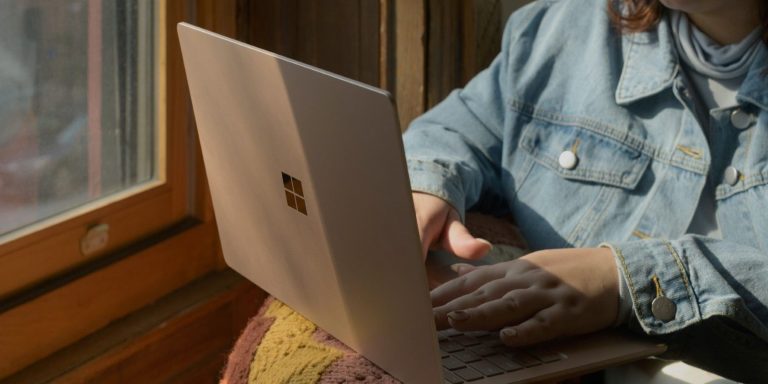 A Woman Sitting On A Chair And Using A Laptop 1.jpg