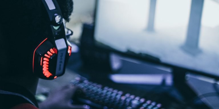 Gamer Using Red And Black Headset For Voice Chat.jpg