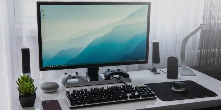 A Black Computer On A Plain White Desk.jpg