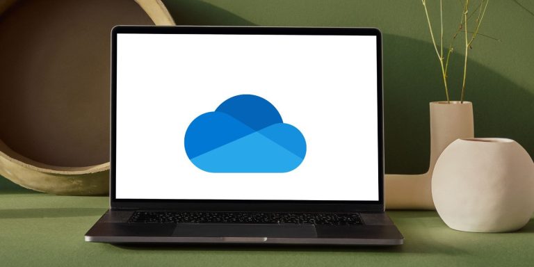 A Laptop On A Table With Onedrive Logo.jpg