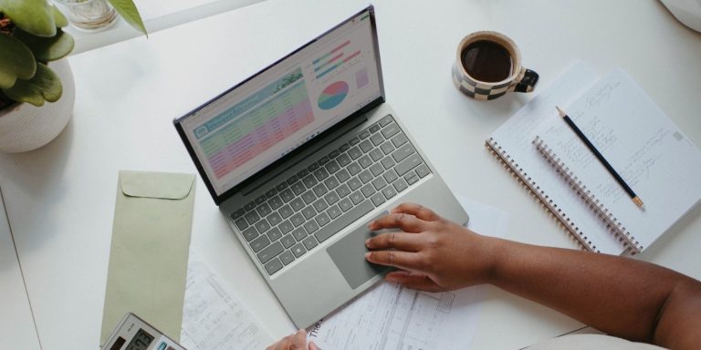 A Person Sitting At The Table With A Laptop.jpg