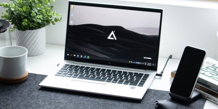 A Silver Laptop On A White Table.jpg