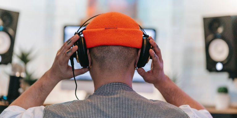 Person Wearing Headphones In Front Of Pc.jpg