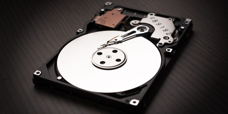 A Computer Hard Disk On A Black Surface.jpg